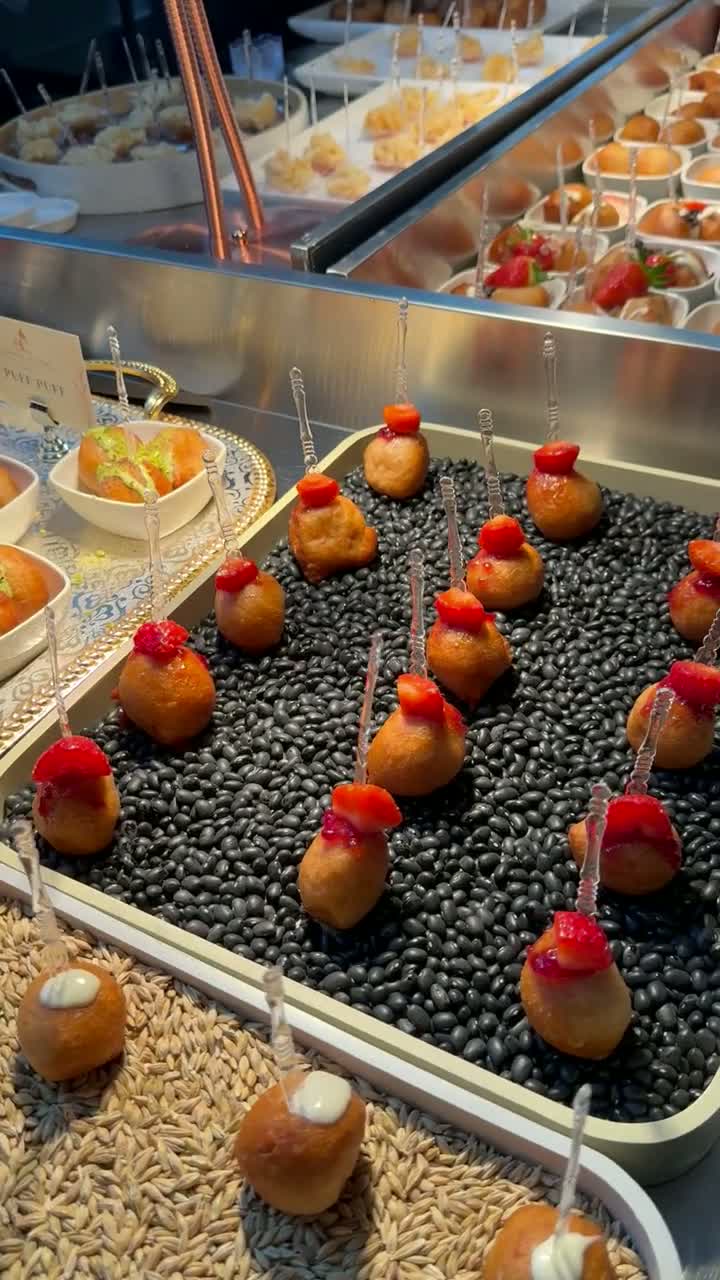 Puff puff and canapé display in the catering kitchen — video