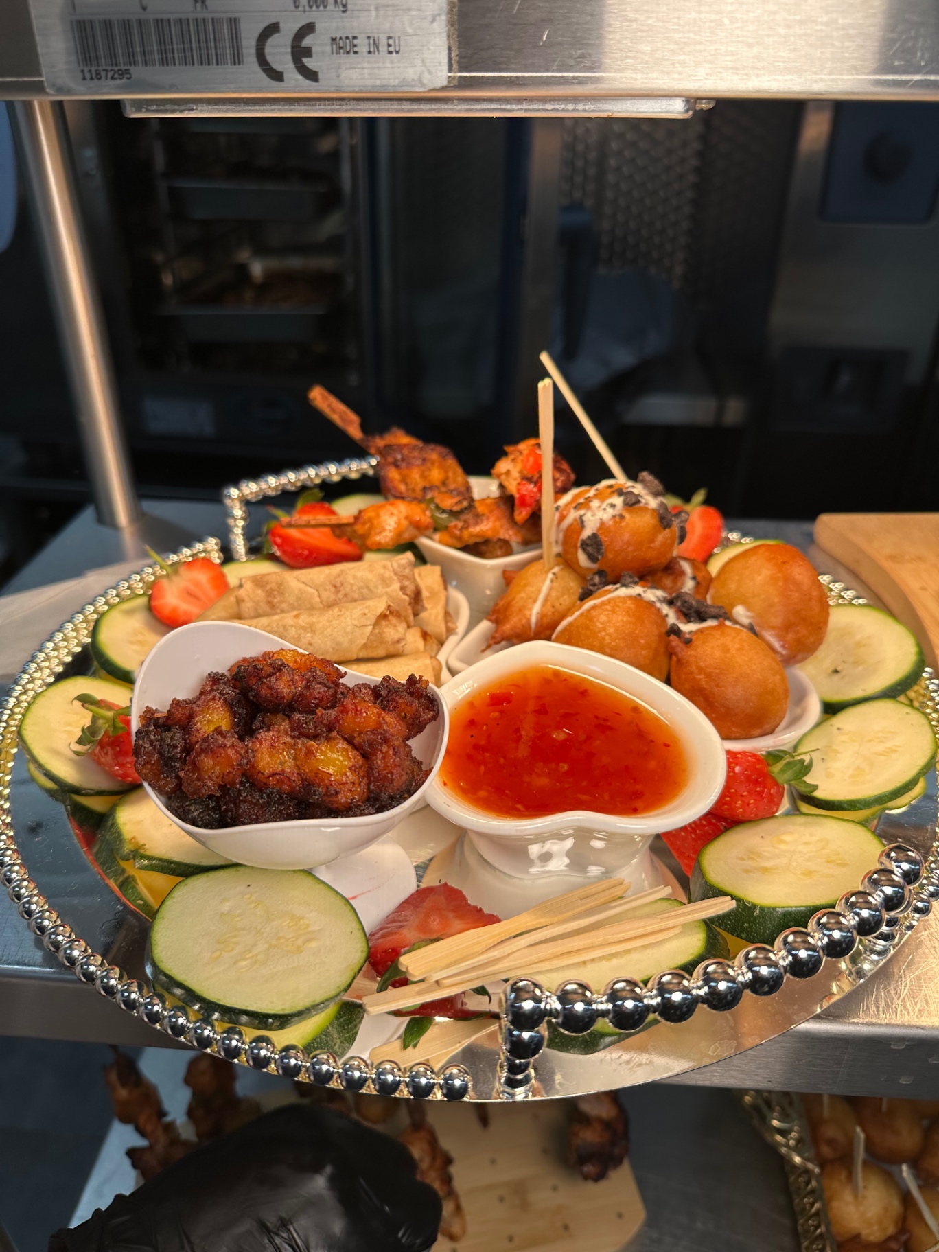 Signature canapé platter with spring rolls, beignets, plantain and sweet chilli