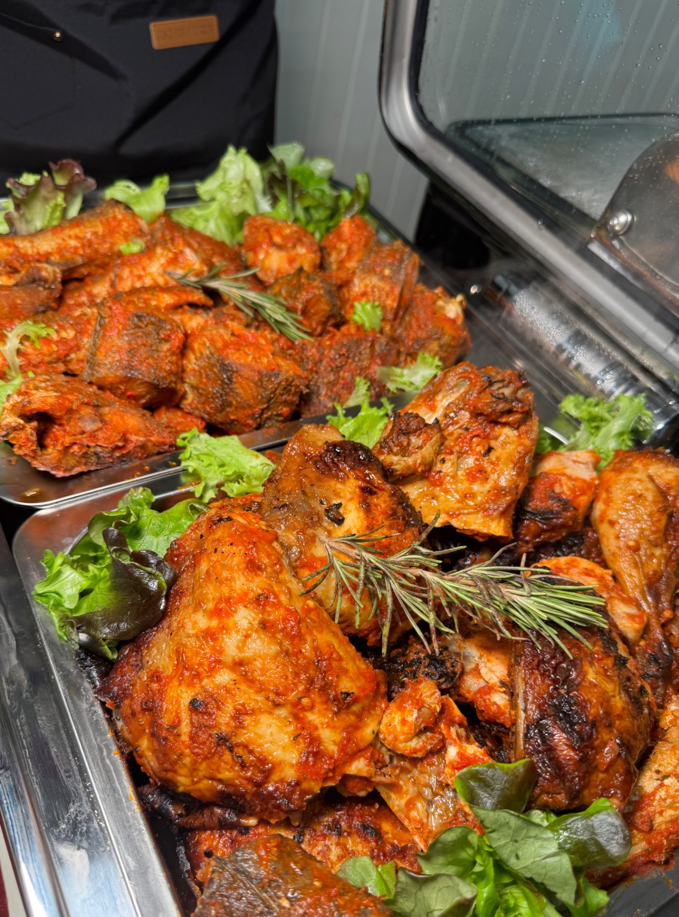 Roasted chicken and peppered fish on a hot buffet